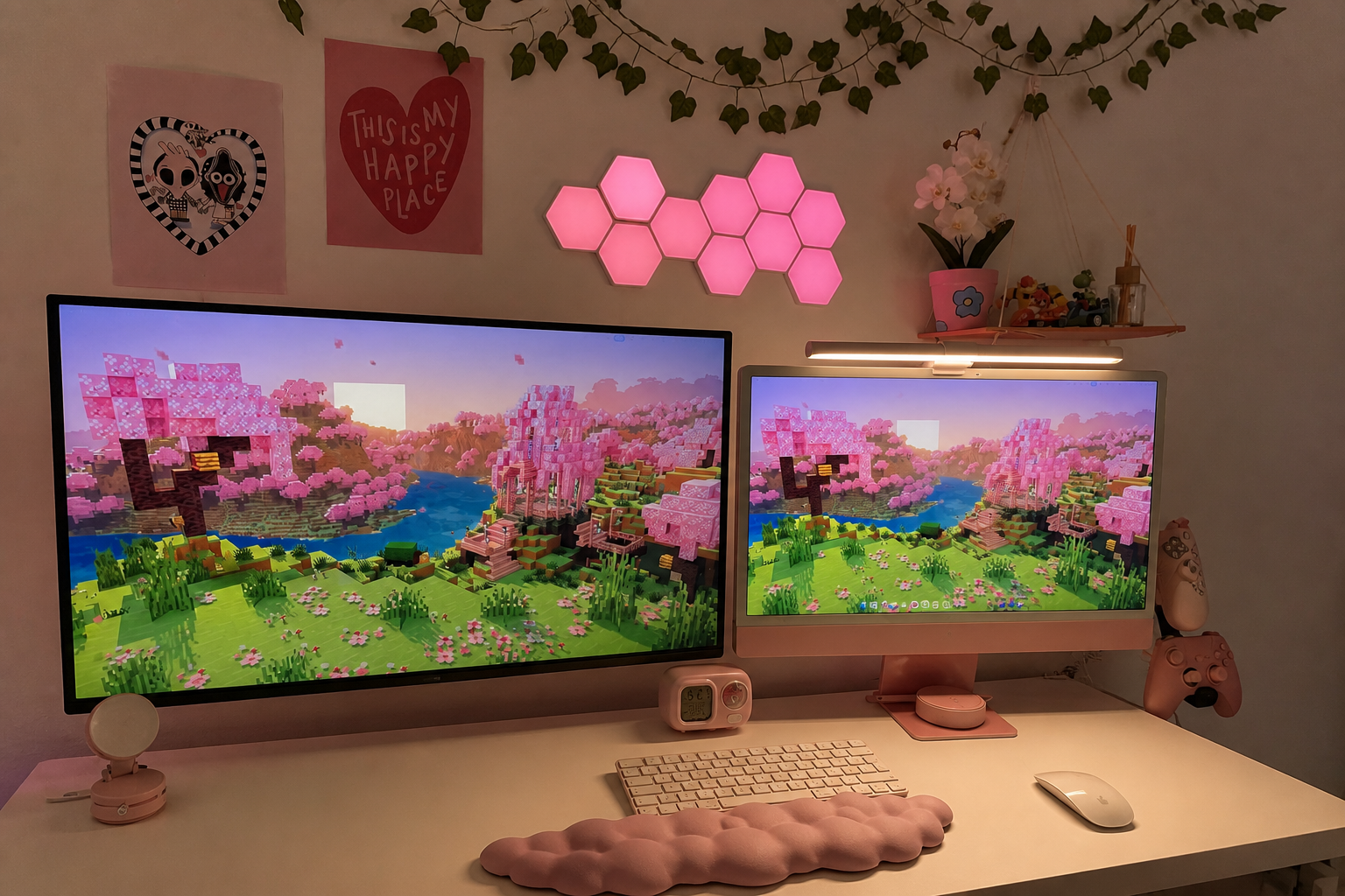 Andrea's cozy pink gaming desk with two monitors, pink wall lights and gaming accessories